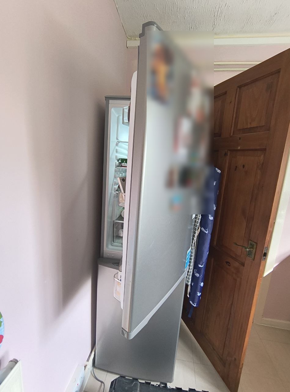 Fridge-freezer before the change, with the door swinging out into the room and across the kitchen doorway